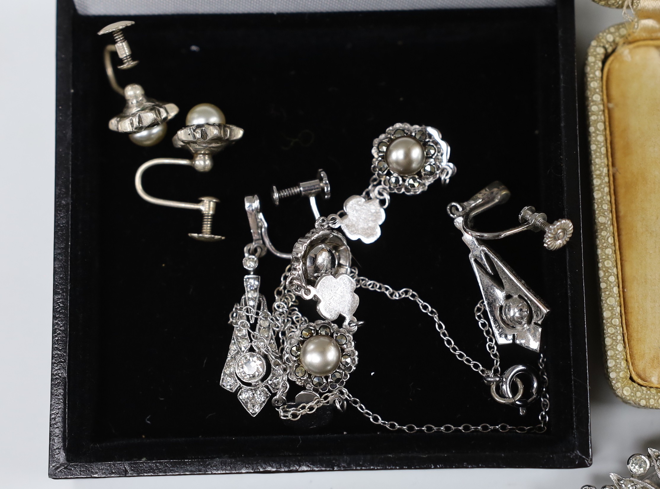 A small group of white metal and paste set jewellery, including a double clip brooch, necklace and three pairs of earrings, three satsuma buttons and a cloisonne ring.